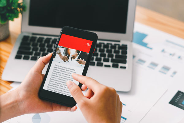 A person scrolling through news on their phone.