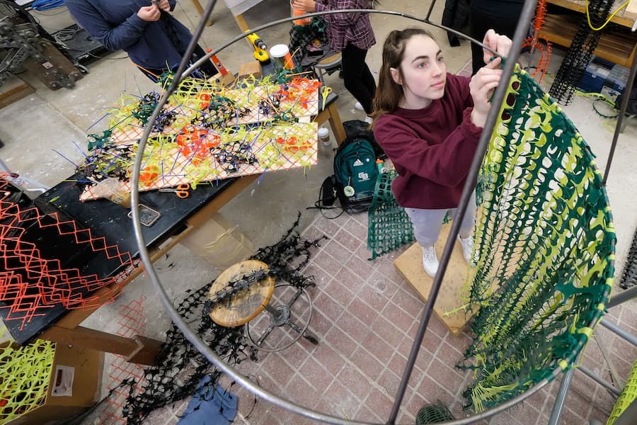 A UWGB Art student builds a sculpture.