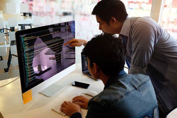 Coworkers working with code