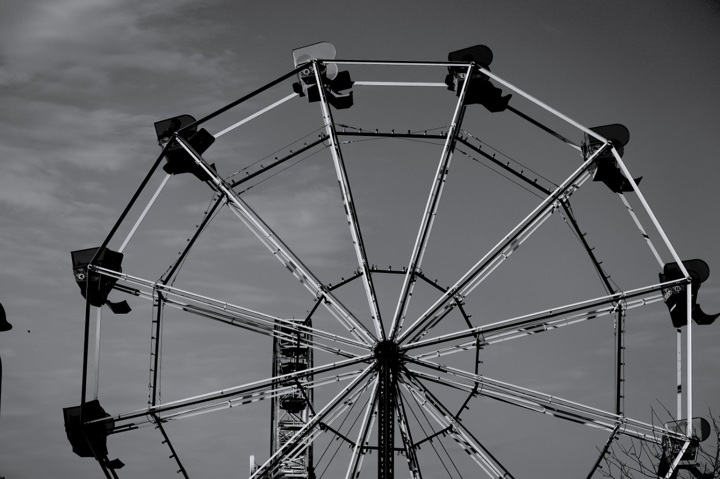 A black and white photo of a ferris wheel.