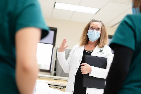 Nurse administrator talks with nurses in clinic