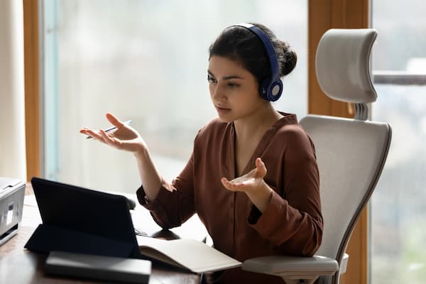 Female employee works from home in ergonomic chair