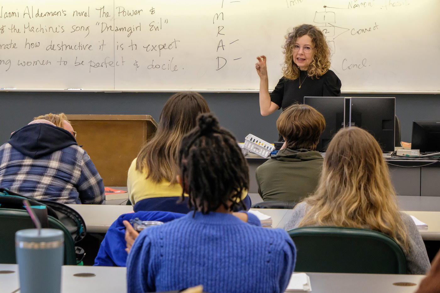 Instructor lecturing to class of students