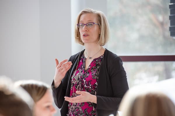 Woman gives speech at Business Week event