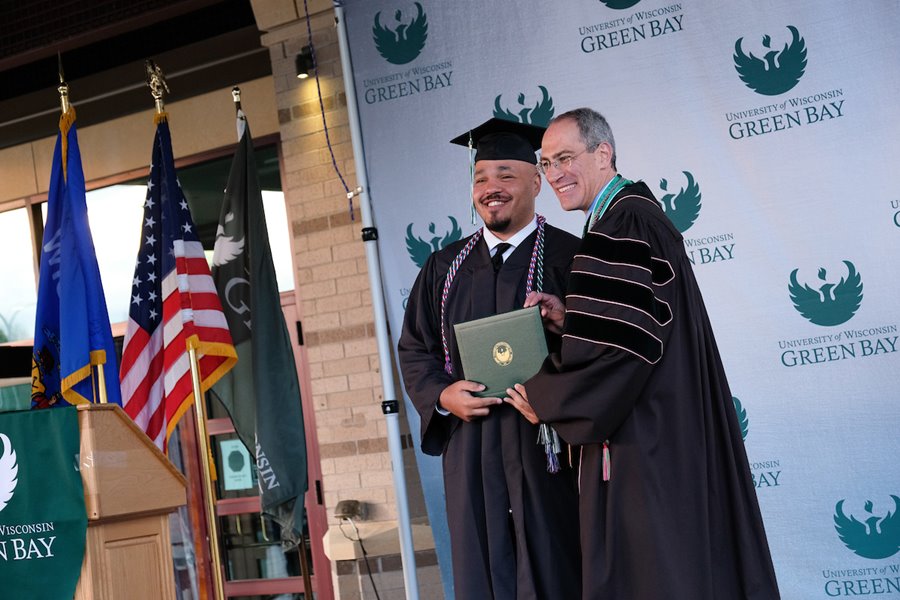 Student and Chencellor at Spring Commencement