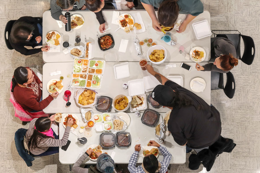 Birds eye view of students eating together at table