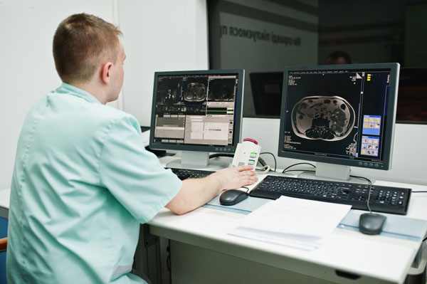 X-ray technician looks over x-rays