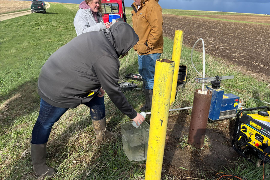 Student participates in well digging