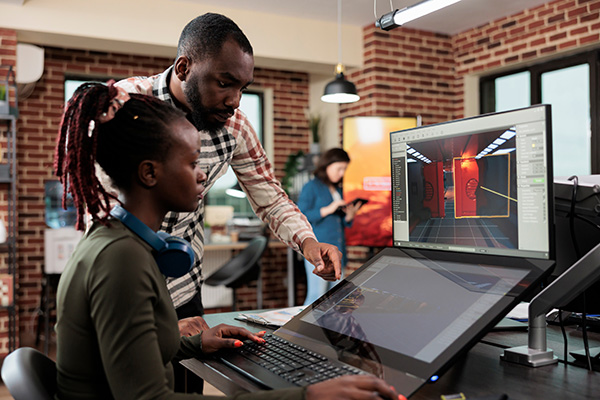 Young adults collaborating at a graphics computer