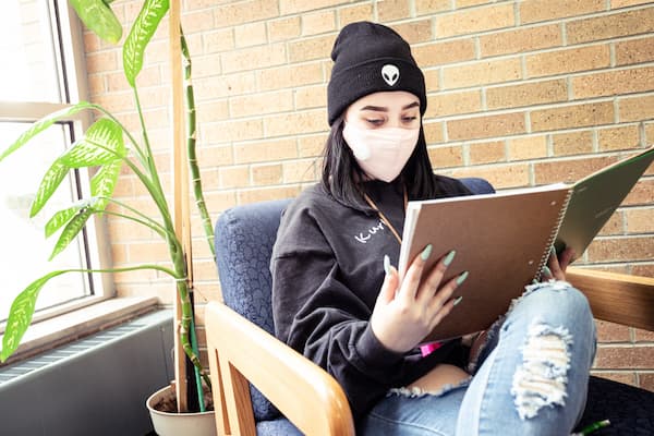 Female studies next to plant