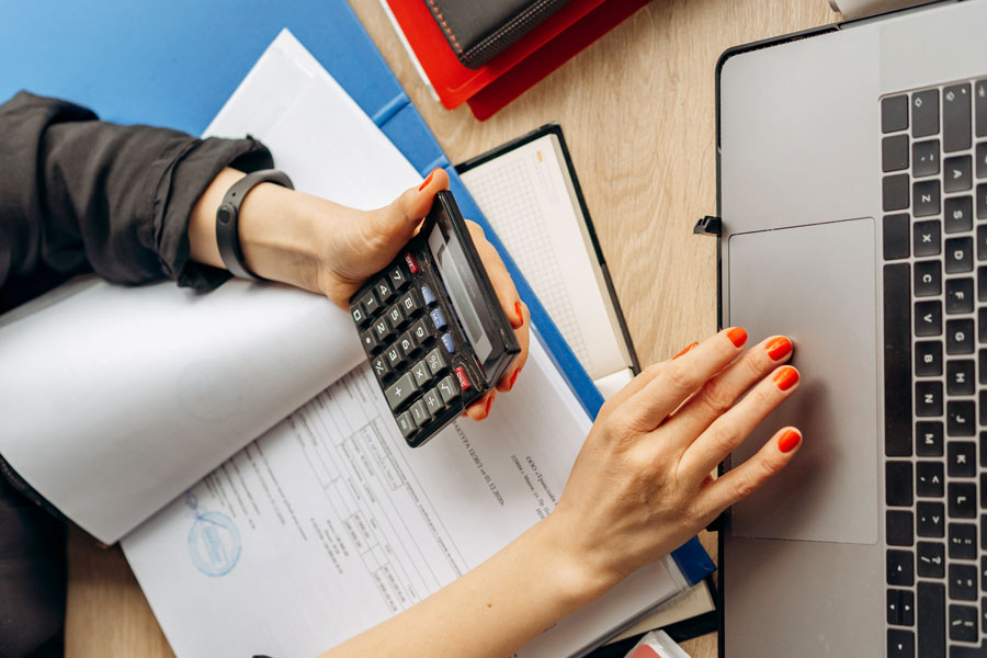 Student using laptop and calculator