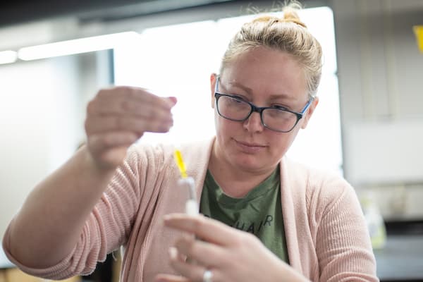 Close up of student performing experiment in lab