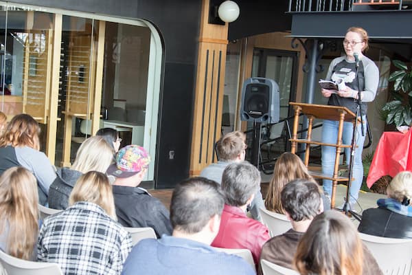 Students listen to speaker read during a Sheepshead Review event