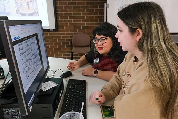 Student and librarian accessing digital archives for a translation project