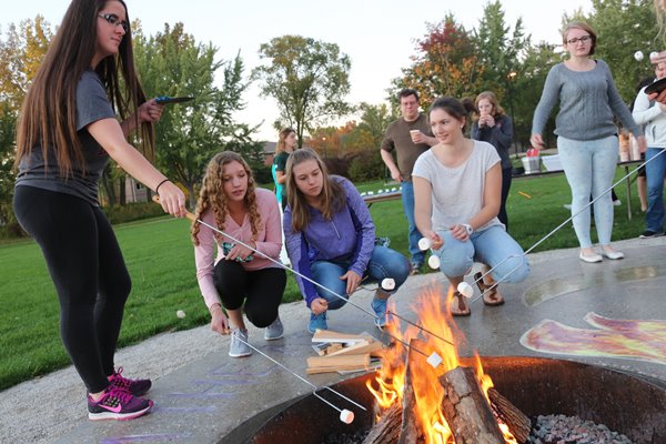 students roasting smores on campus