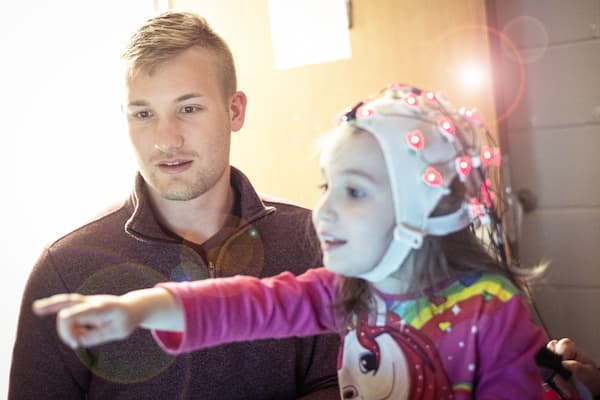 Male student preforms eeg study on child