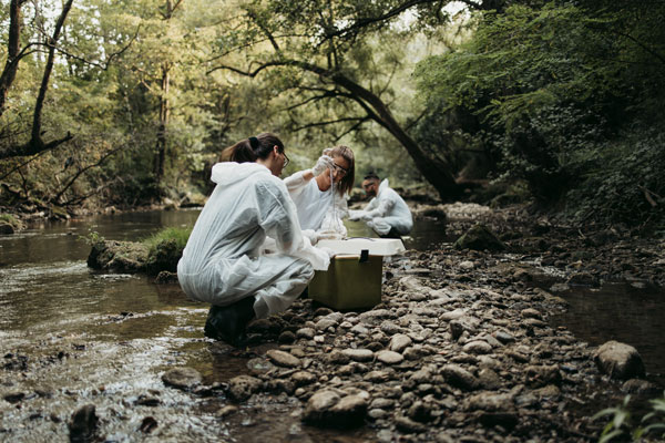 Water scientist collecting water samples