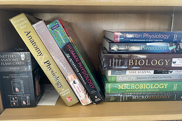 Biology and physiology books on a shelf