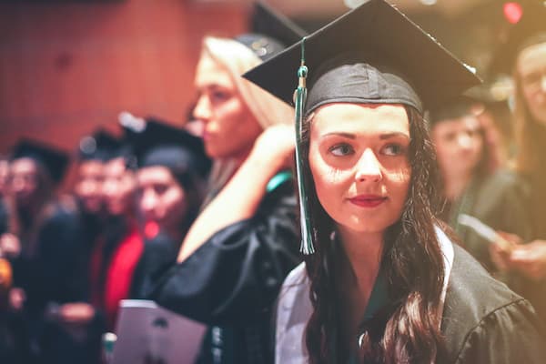 Student wearing graduation cap and gown at commencement