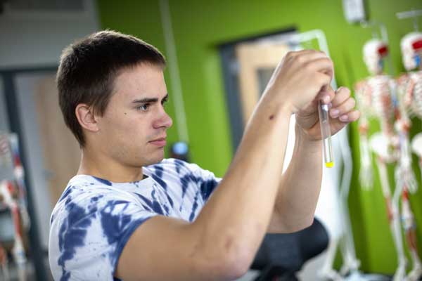 Student holds up test tube