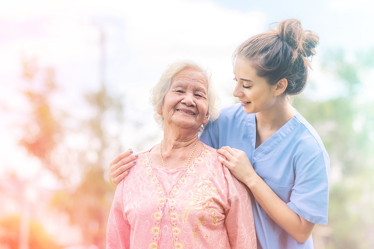 Smiling caregiver taking resident outside