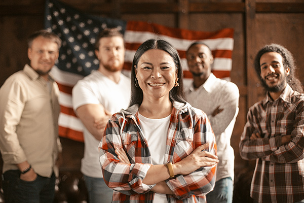 Ethnically diverse people in front of American flag