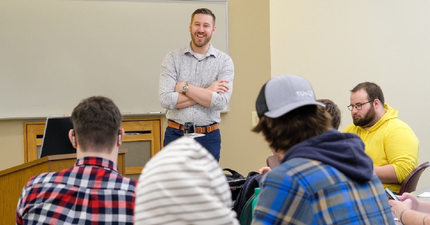 smiling instructor facing students