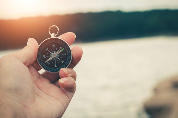 Hand holding compass