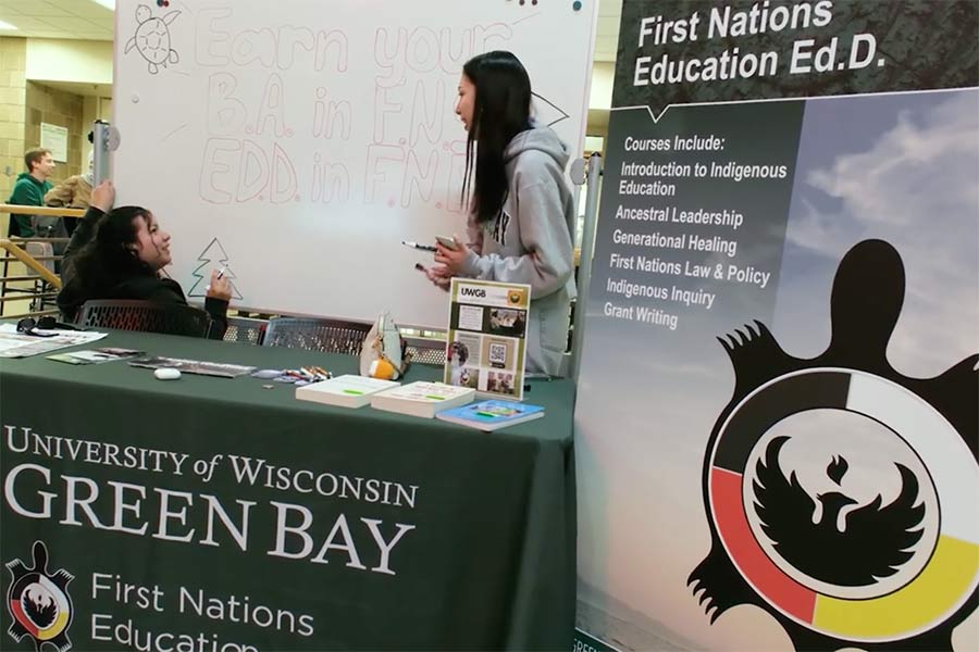 First Nations students work at an information table.