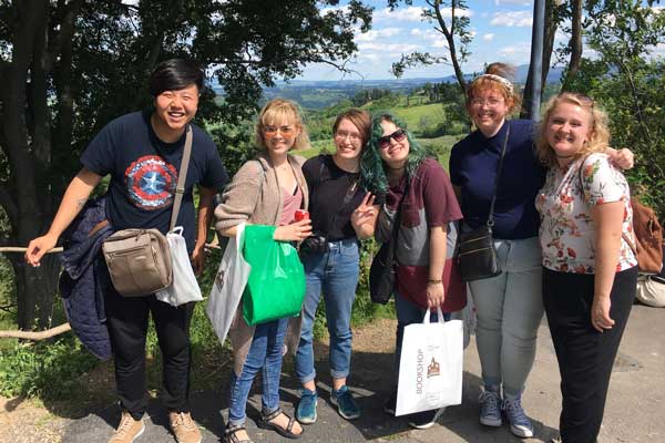 Students take group photo outdoors