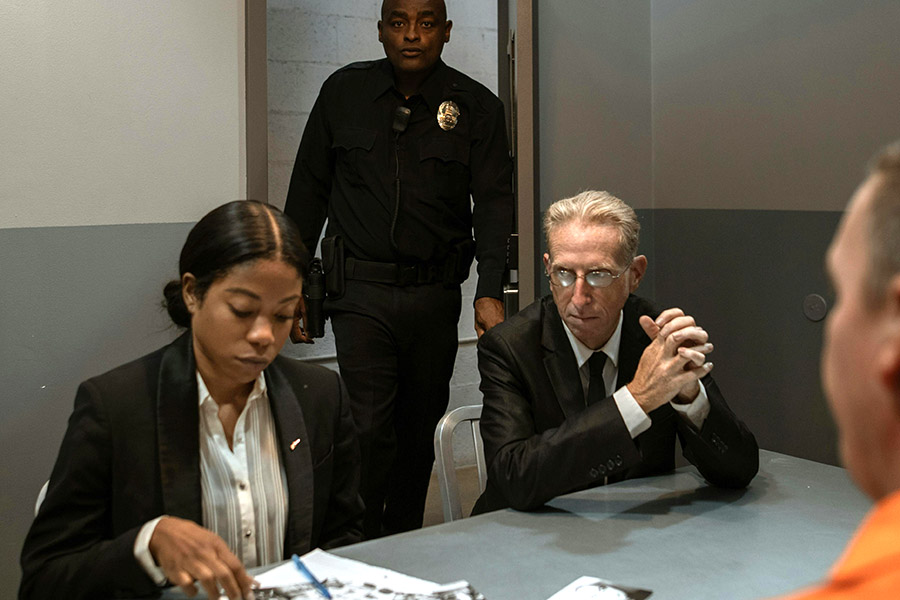 Lawyers and guard meeting with inmate