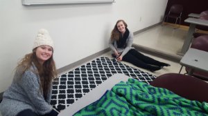 Two women making blankets for veterans