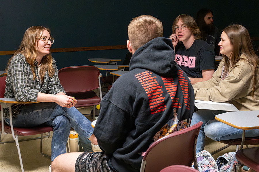 Mickey Schommer, German major, left, discusses the current news of the day with her group during Deutsche Kultur und Landeskunde class