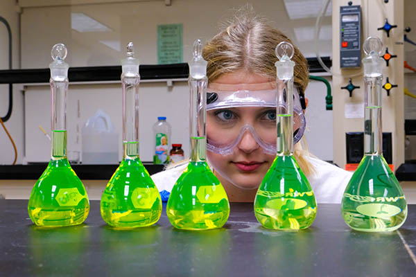 Student in lab with beakers