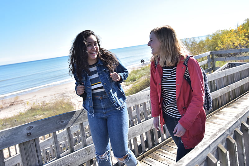 students walking along lake michigan