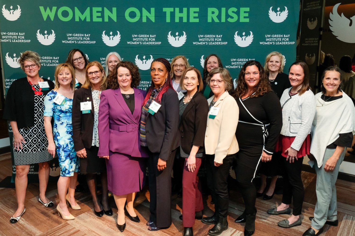 advisory board poses in front of women on the rise background