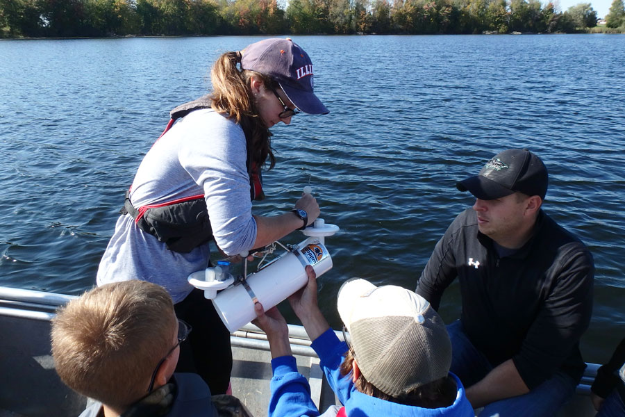 Student and professor on boat performing research