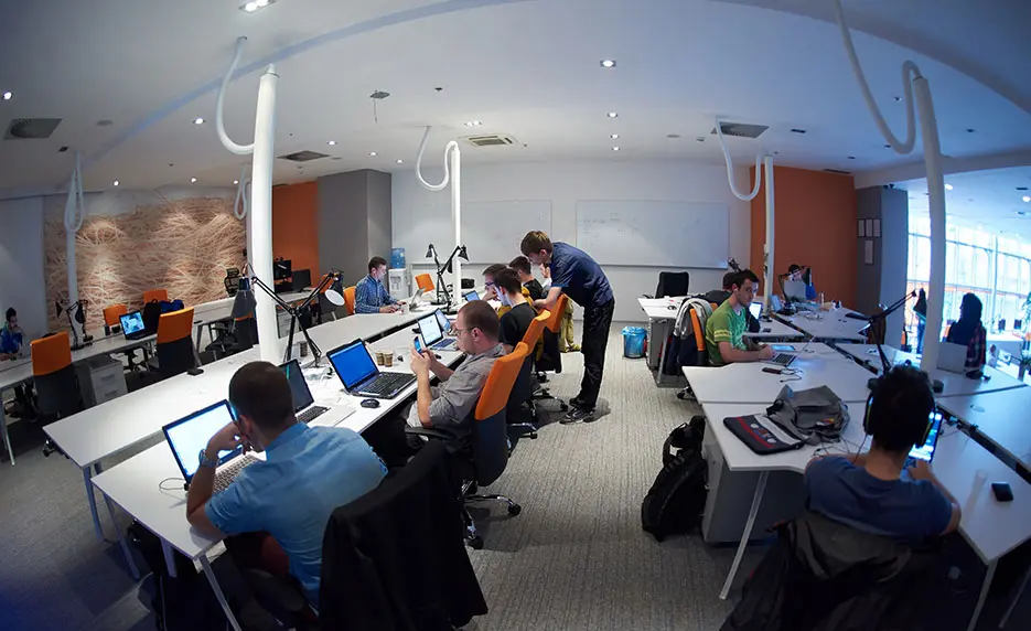 A group of people working in a programming hub