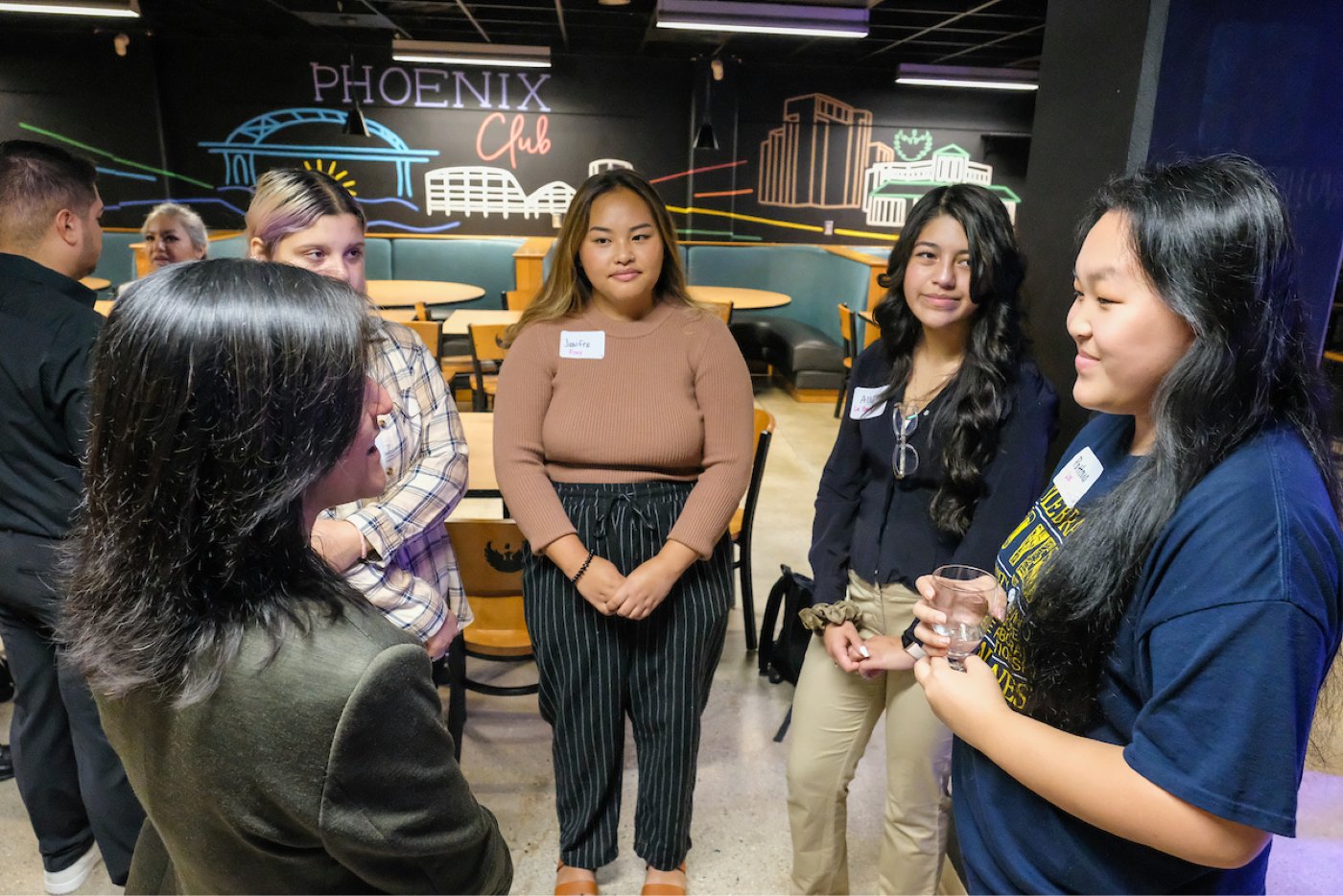 A group of students gather around for a networking event in the Phoenix Club.