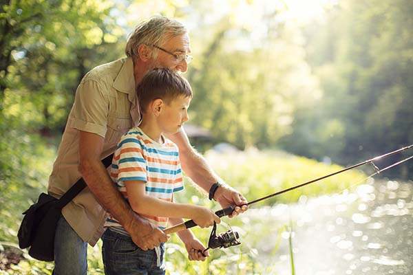 grandfather fishing with grandson