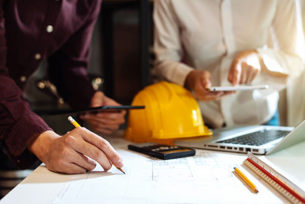 Business men discuss data on construction site