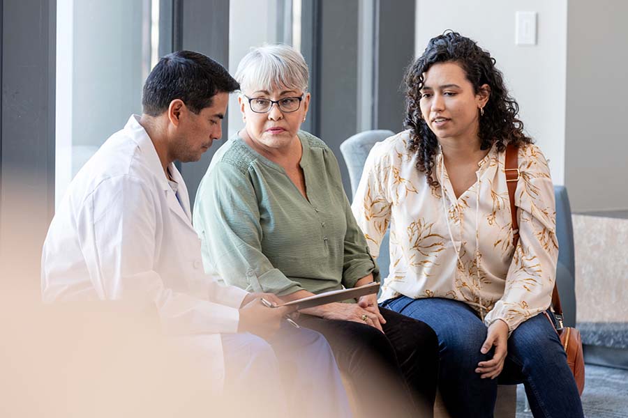 senior woman speaking to doctor with help of interpreter