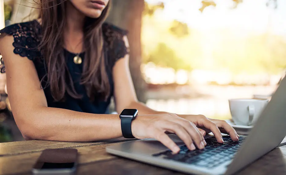 a woman working on a computer keyboard