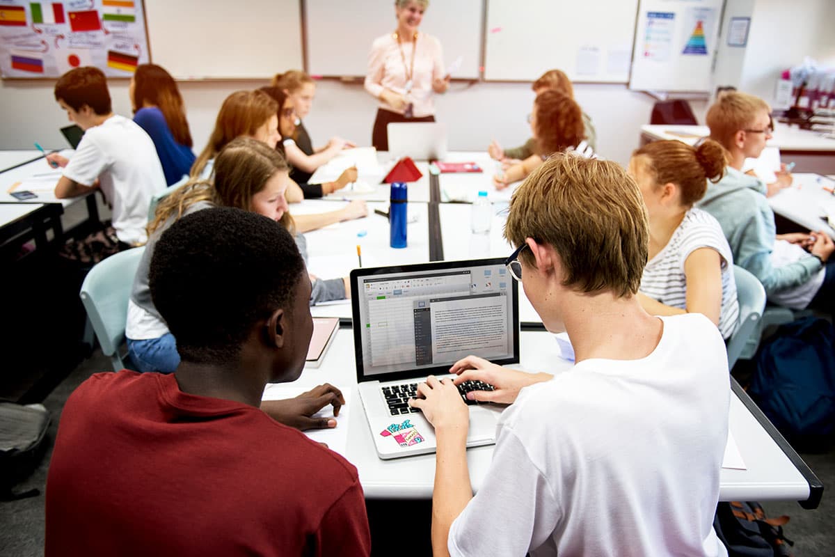 students sitting at table working together during class