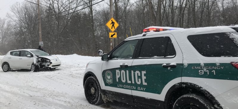 Police car responding to car crash in winter