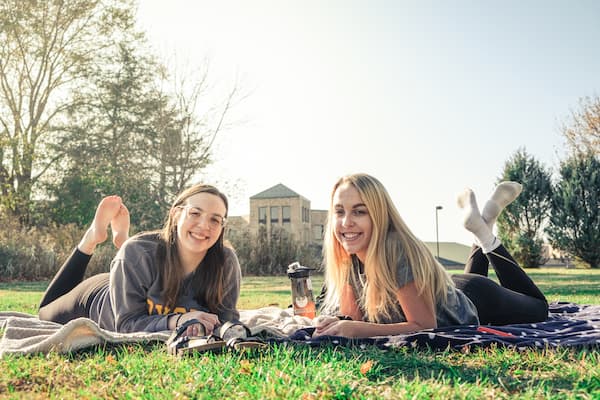Two female students hang out outside