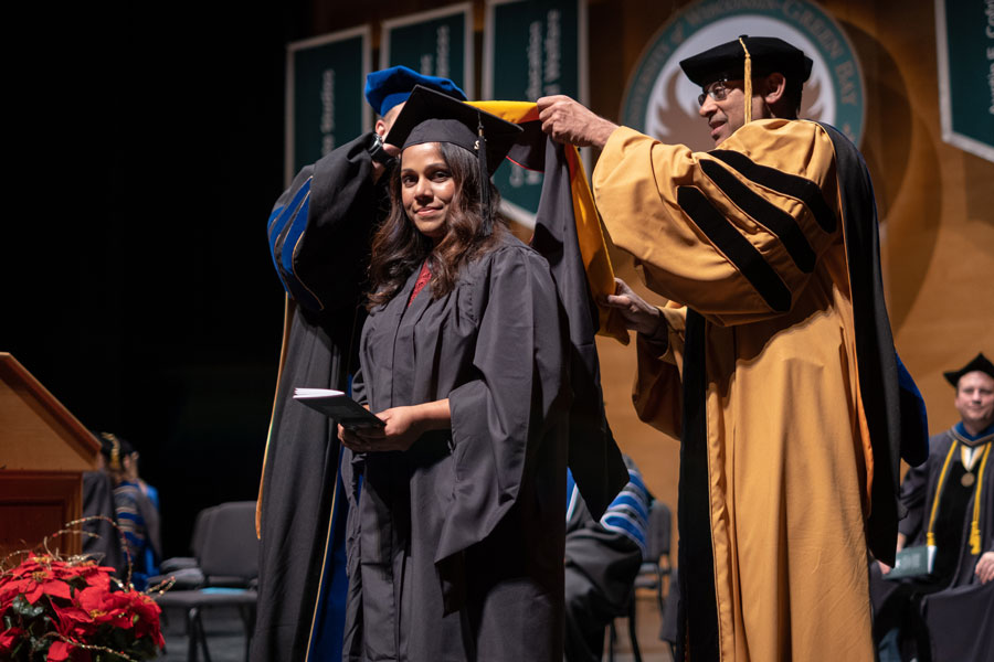 Student recieving Master's stole at commencement