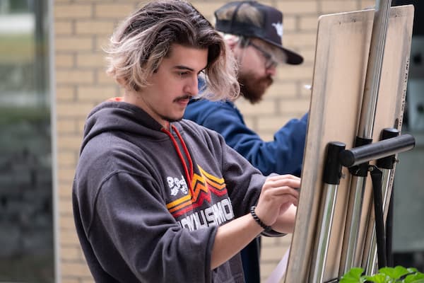 Teacher shows student drawing techniques