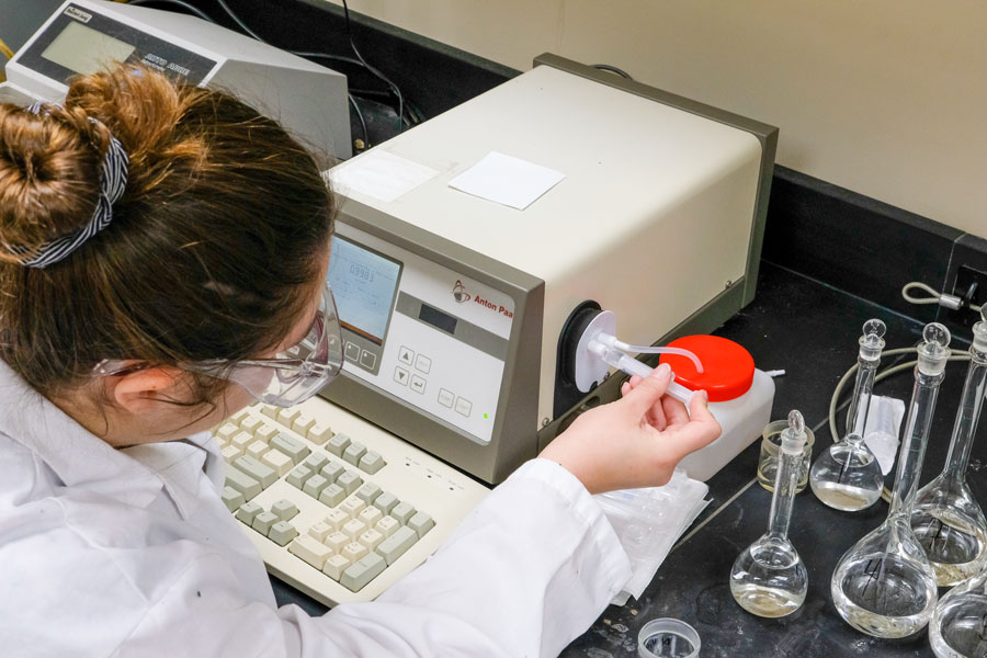 Student in lab using advanced equipment