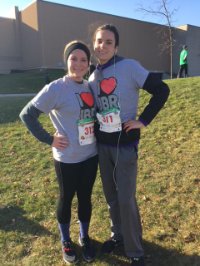 Two people posing after Jingle bell run